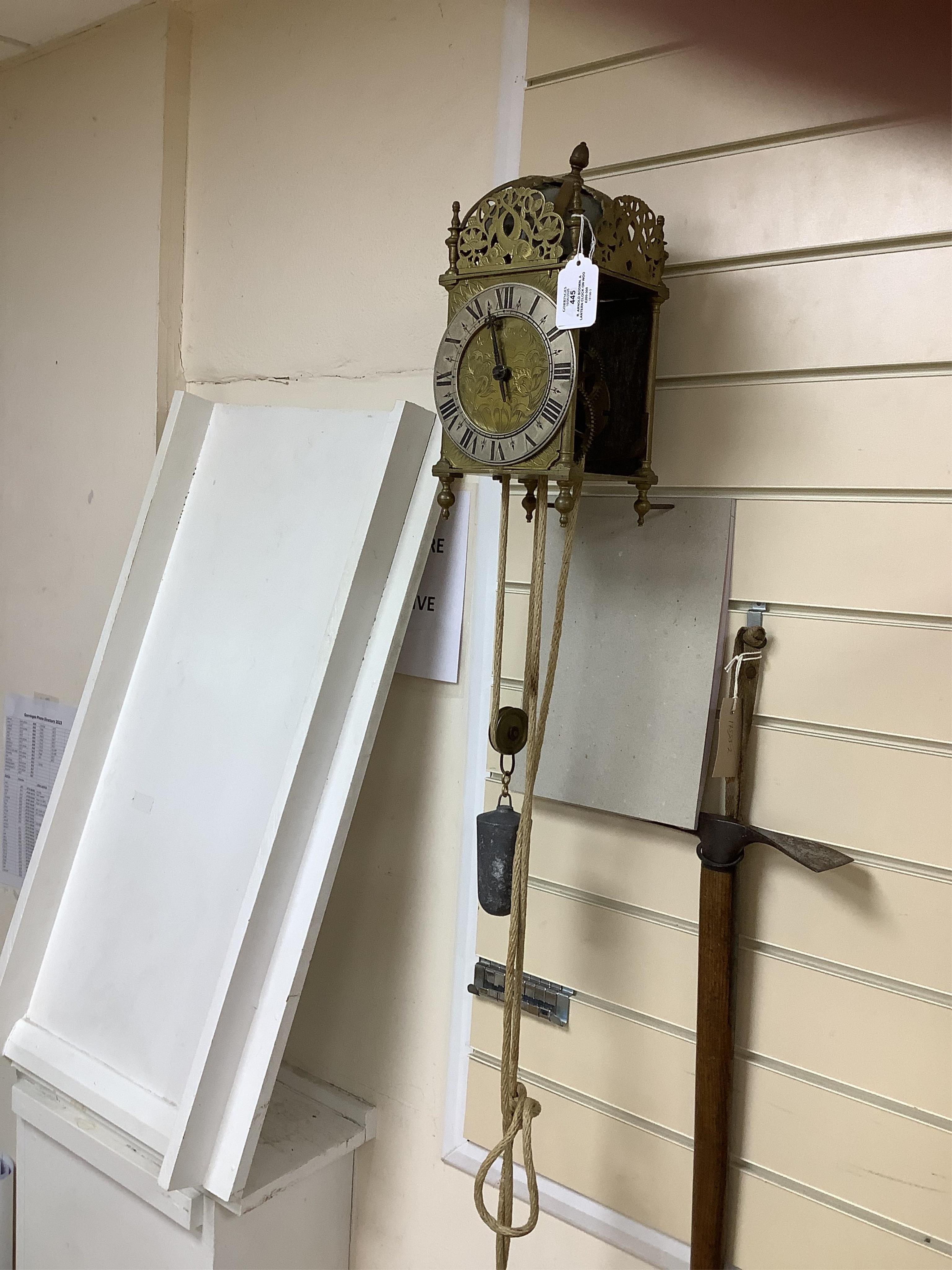 R. Arnold, Bodmin, a lantern clock on wooden wall shelf, clock 32cm high